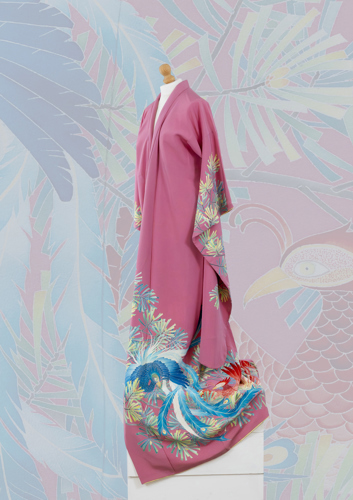 a pink kimono with design on the bottom and sleeves