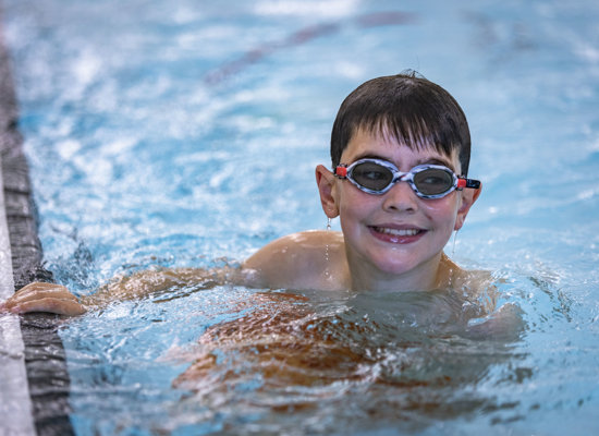 Boy in the swimming pool with his goggles on