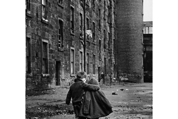 two children walking down a street