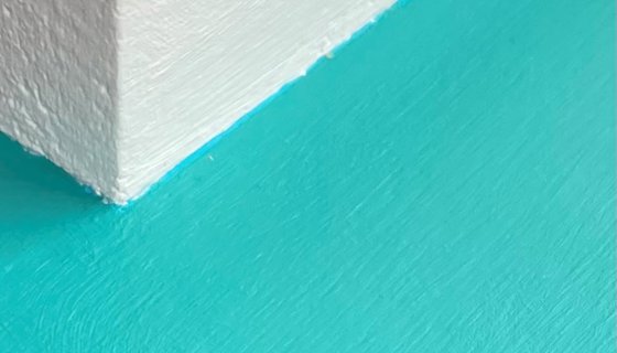 White wall with a light blue ledge attached to it