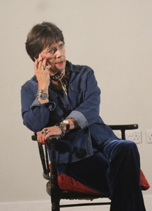 Pat Douthwaite sitting on a chair holding a cigarette